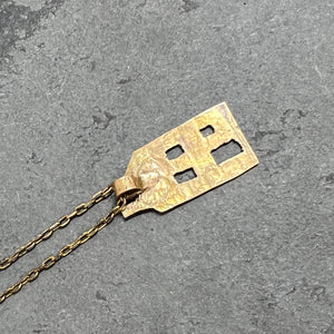 Bronze Pittsburgh Row House on raw brass chain with an antique finish.